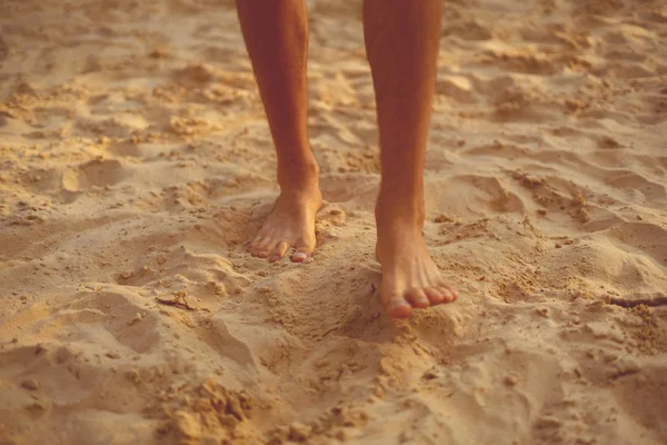 bare male feet walk on the sandy beach, healthy yoga practice concepts