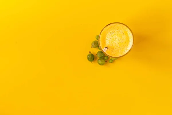 top view of a summer cool smoothie drink on a color surface with copy space