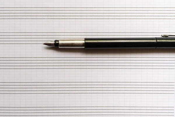 empty blank music notebook with fountain pen, copy space mockup, macro shot