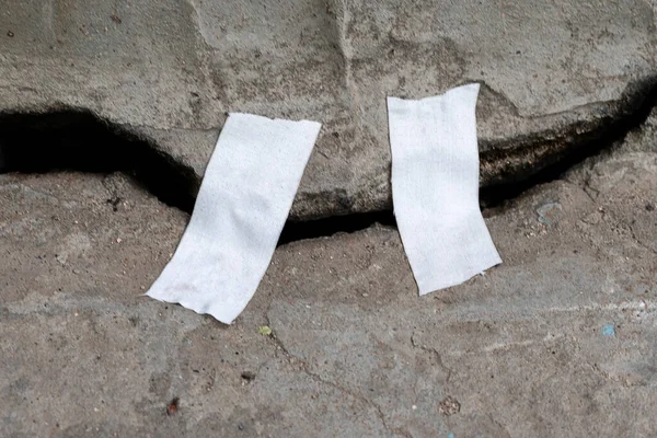a crack in the concrete, symbol of the earthquake disaster catastrophe, sealed with a tape, help concept