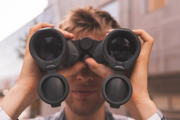 close up tourist holding binocular and searching the way, macro lens views