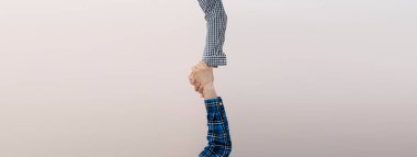 İki el birbirini destekler, tokalaşır, renkli arka plana karşı izole olur.