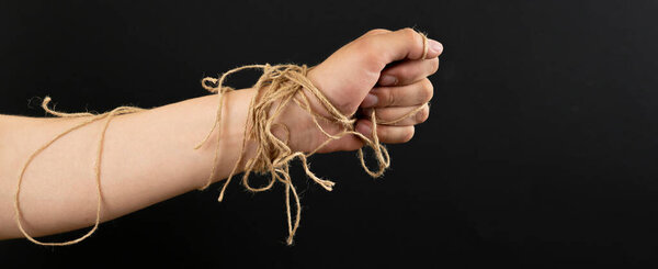 person's hand in the rope tighten against the colorful background, symbol of personal rights and laws wide web banner