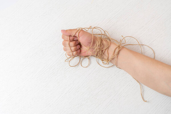 person's hand in the rope tighten against the colorful background, symbol of personal rights and laws