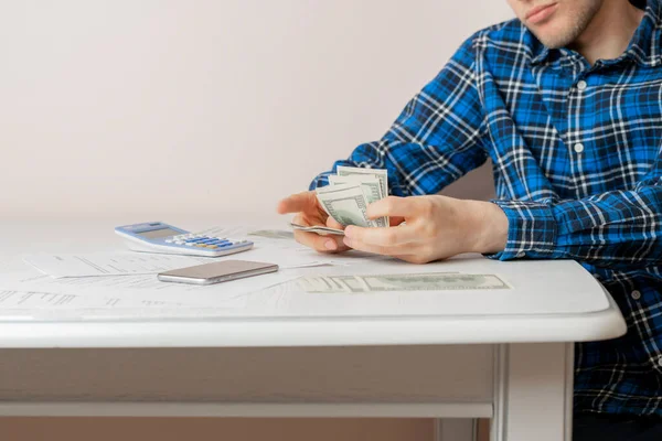 counting cash money, person calculate personal earnings and savings at the table