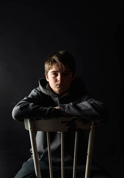 Low Key Portrait Adolescent Boy Sitting Chair Dark Room — Stock Photo, Image
