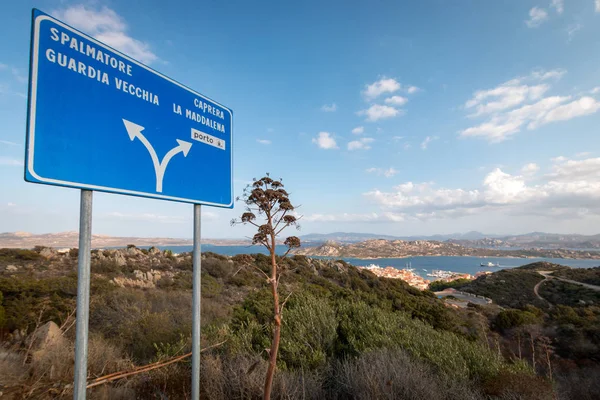 Blue street sign with arrows on the Italian island of La Maddalena giving direction to Spalmatore, Guardia Vecchia, Caprera, La Maddalena and porto on scenic viewpoint