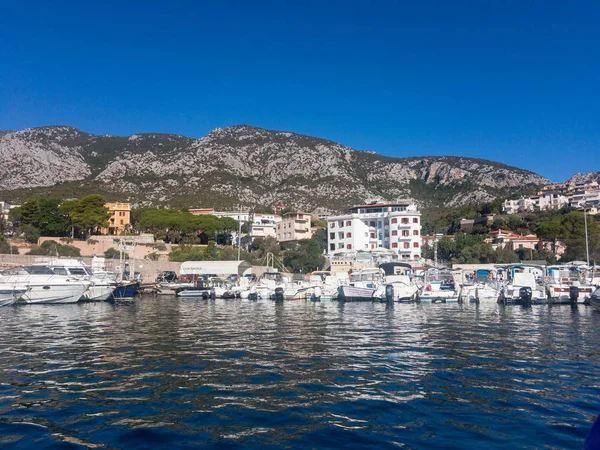 Panoramic view of Cala Gonone with many rental boats in the water on the Italian island of Sardinia