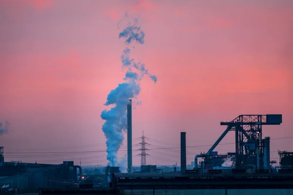 Scenic view of industrial landscape of ruhr area in Germany at sunset against colorful sky