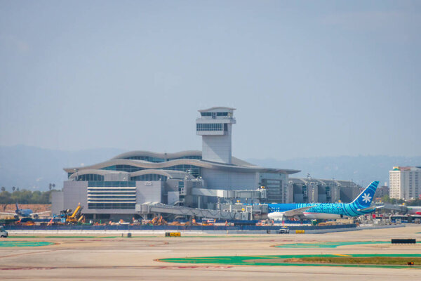 Los Angeles, California, USA - April 19, 2024: An Air Tahiti Nui Boeing 787-9 parked Tom Bradley Internationl Terminal, Los Angeles International Airport LAX against cloudy sky