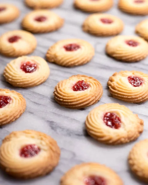 Raspberry Swirl Shortbread Cookies on a Marble Pastry Board