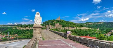 Entrance to the Tsarevets fortress with the Patriarchal Cathedral of the Holy Ascension of God in Veliko Tarnovo, Bulgaria. Big size panoramic view on a sunny summer day clipart