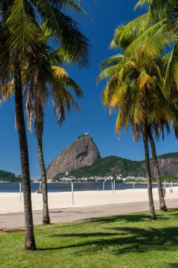 Güneşli bir günde, Rio de Janeiro, Brezilya 'daki Covid-19 salgını sırasında boş bir sahilden Sugar Loaf Dağı' na güzel bir manzara