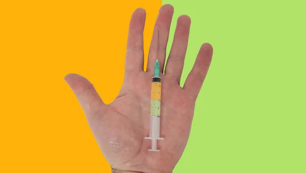 Syringe Open Hand Orange Green Backgrounds — Stock fotografie