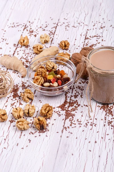 healthy brown smoothie with walnut and candied fruits lie on the table