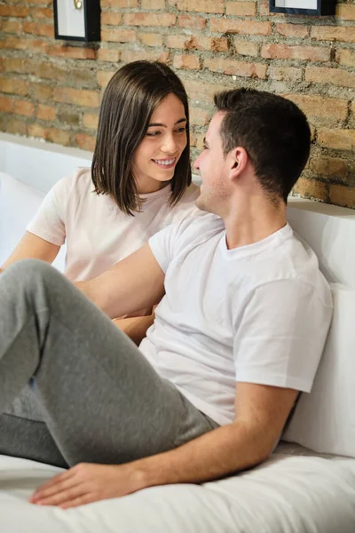 Romantic Young Couple Looking Each Other While Relaxing Bed Home — стоковое фото