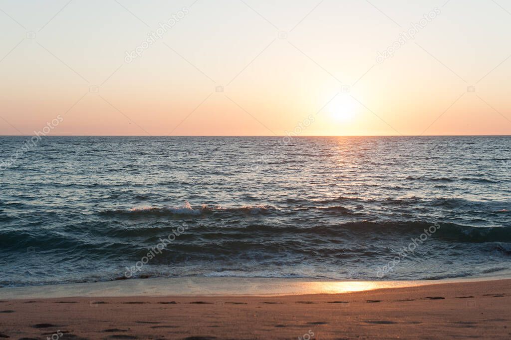 Sun setting over Pacific Ocean at beach in Mexico