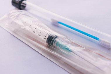 syringe and test swab  on a white background.