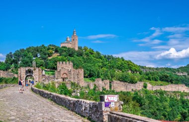 Entrance to Tsarevets fortress with the Patriarchal Cathedral of the Holy Ascension of God in Veliko Tarnovo, Bulgaria, on a sunny summer day clipart