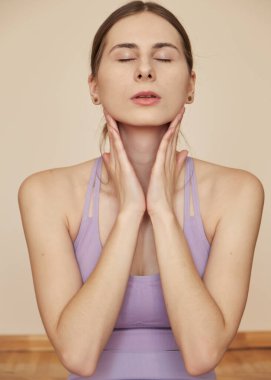 Gözlüklü genç kadın evde meditasyon yapıyor.