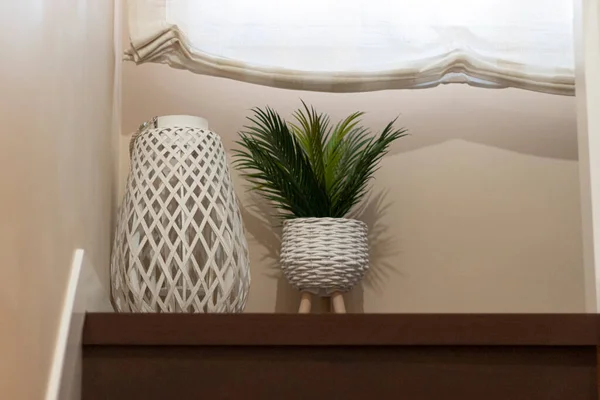 decoration detail in neutral tones, consisting of a white wooden candl