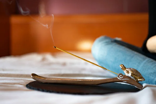 Incense stick lit in a yoga and meditation session. Incense concept.