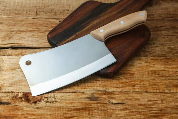 cleaver knife on wooden board
