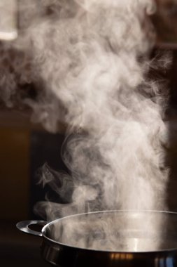 Detlle of smoke coming out of a boiling saucepan