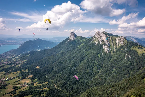 Paragliders & Hang Gliders Fly Over Granite Alps, Lake Annecy, France