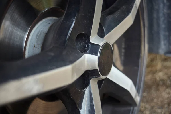 Detail of a wheel rim the aftermarket sports league of a car.