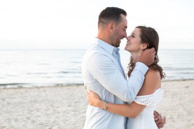 romantic loving couple posing at the ocean beach