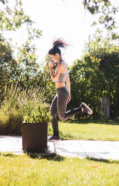 Young Woman Exercising Her Home Garden — стоковое фото