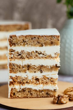 Beyaz kremalı ve fındıklı bir dilim pasta.