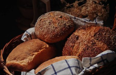 Arkaplanda susam tohumları ve buğdaylı taze pişmiş ekmek.