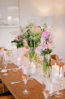 Çiçekler ve mumlarla düğün masası.