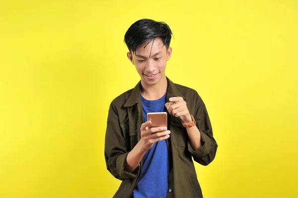 Happy Young Good Looking Asian Man Smiled Using Smartphone Isolated — Stok Foto