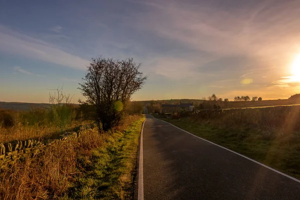 Side road captured during early morning sunset with nice sky, clouds and colors around road