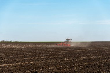 Traktör tarlaları sürüyor. Araziyi sonbaharda ekime hazırlıyorum..