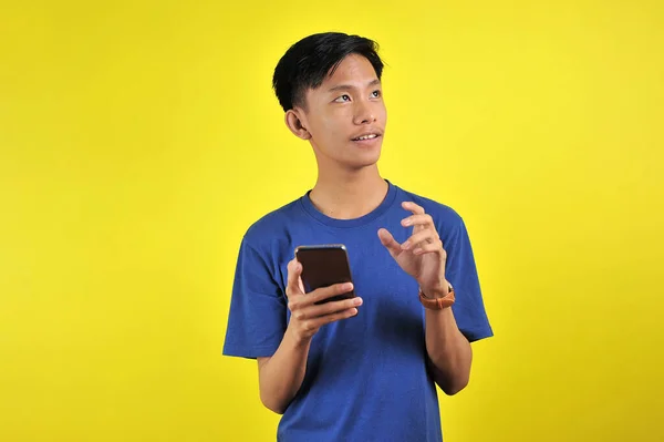 Happy Young Asian Man Smiling Using Smartphone Looking Blank Area — 스톡 사진