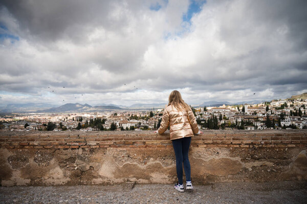 young woman with backpack on the beach