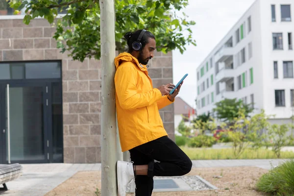 Young Man Yellow Jacket Headphone Tablet — Stock Photo, Image