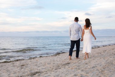 romantic loving couple posing at the ocean beach