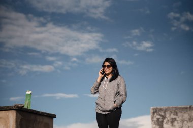 beautiful Hispanic woman using her phone after training