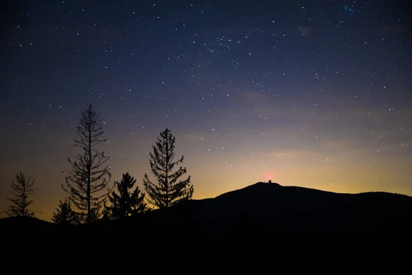 Sunset with stars in the sky and a gradual milky way view of Lysa Hora Czech Republic.