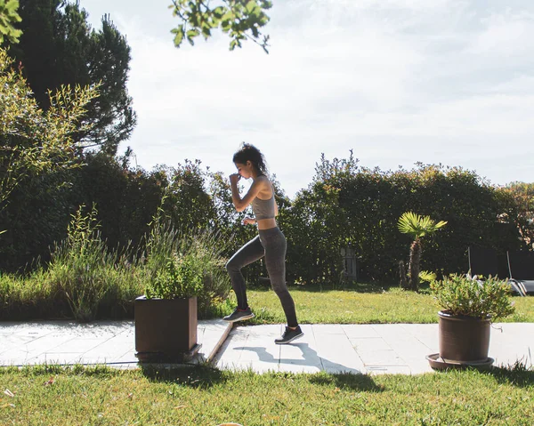 Young Woman Exercising Her Home Garden — стоковое фото