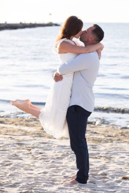 romantic loving couple posing at the ocean beach