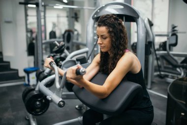Beautiful fit woman working out at indoor gym