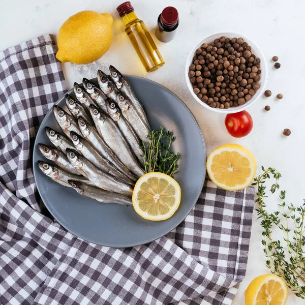 Raw anchovy fish cooking and ingredients.