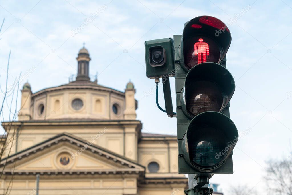 Traffic light in Milan Garibaldi infront of a church