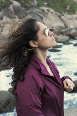 Kumsaldaki genç ve güzel bir kadının portresi.